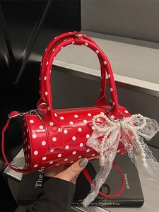 Polka dot red patent leather Boston bag with pearl bow charm and shoulder strap