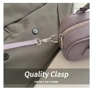 Detailed macro view of high-quality silver hardware hooks on a purple lavender bowling bag