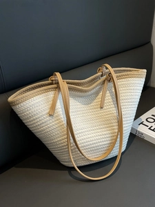 Elegant woven straw tote bag with khaki shoulder straps for summer beach vacations