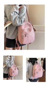 Detail of pink faux leather backpack with litchi texture and cute pompom keychain