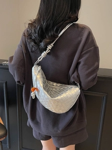 Silver woven crescent moon bag with metallic texture and orange bead charm detail