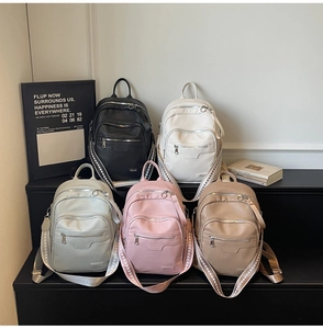 Five assorted minimalist solid color backpacks in PU leather with textured shoulder straps