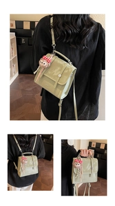 Detail of mint green versatile bag with detachable straps and cute plush pendant