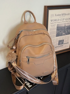 Chic camel pebble leather backpack with multi-zipper pockets and woven strap