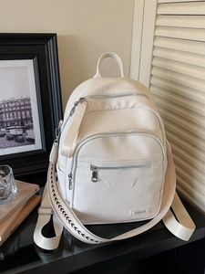 Minimalist white lychee grain backpack with multi-zipper pockets and stylish wide strap