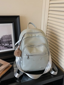 Mint green litchi texture backpack with multi-zipper pockets and brown plush ball charm