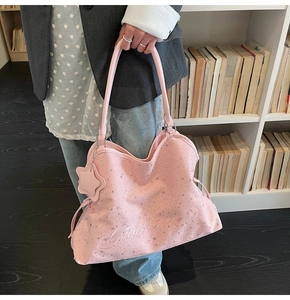 Détail du sac cabas rose avec imprimés étoiles argentées et broderie de lettres