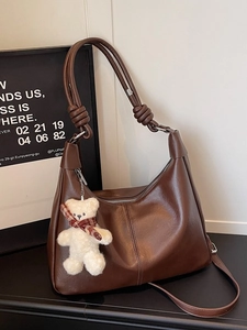 Large dark brown leather hobo bag with knotted strap and cute plush bear charm