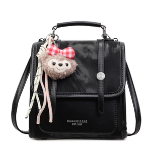 Chic black leather handbag with crossbody strap and cute plush charm for women