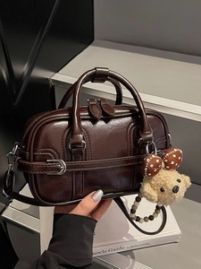 Fashionable dark brown shiny Boston bag with plush bear charm and detachable strap