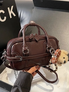 Deep brown vintage Boston handbag in glossy leather with a cute plush bear charm
