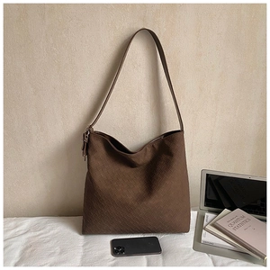 Detail of a brown woven leather tote bag with Intrecciato texture for office commute
