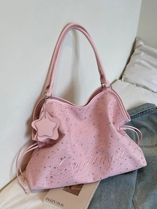 Grand sac cabas rose à motif d'étoiles avec broderie présenté dans un décor cosy