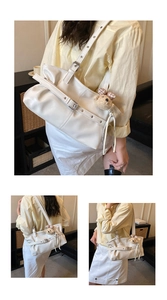 Detail of white pleated cloud tote bag with adjustable shoulder strap and cute bear charm
