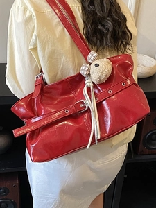 Glossy red patent leather tote bag with silver buckle and cute plush bear charm
