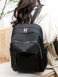 Lightweight black oxford fabric backpack for women with gold zippers and multi-compartments