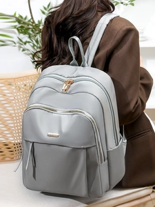 Modern light grey Oxford fabric backpack for women with gold zippers and spacious compartments