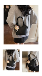 Detailed view of black litchi pattern bucket bag with cute teddy bear and bead charm