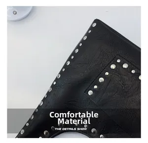 Detail of black oiled leather texture with silver metal rivets on shoulder bag