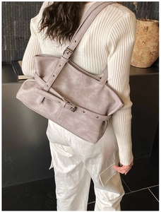 Detailed view of lavender faux leather tote with metallic eyelets and strap texture