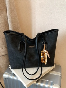 Black tote bag with animal and heart embossing and retro beaded charm on books