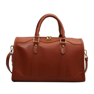 Classic brown leather boston bag with top handles and adjustable shoulder strap for women
