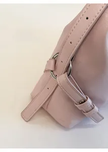 Detail of adjustable leather strap with premium silver circular metal ring hardware