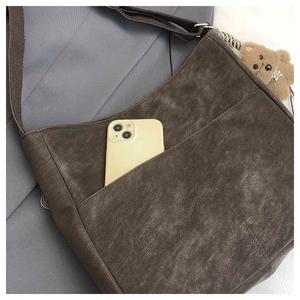 Brown vintage textured tote bag with front pocket, phone slot and plush bear charm