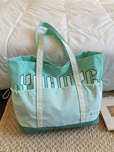 Large capacity green nylon tote bag with side drawstring pocket and white letter print
