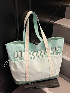 Three-tone green nylon tote bag with YOUNG print and adjustable side drawstring