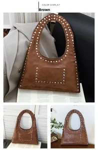 Detail of vintage brown oil wax leather shoulder bag with silver rivet studs
