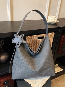 Chic grey woven leather shoulder bag in half-moon shape with a star charm pendant