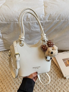 White litchi pattern bucket bag with teddy bear charm and adjustable shoulder strap