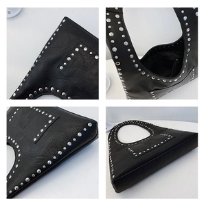 Detail view of black vintage rivet shoulder bag showing interior lining and silver studs