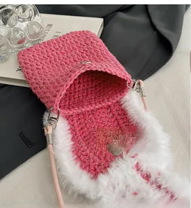 Detailed interior view of pink crochet phone bag with white plush trim and silver hardware