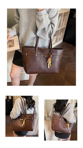 Detail of dark brown tote bag with vintage leather texture and gold twist lock clasp
