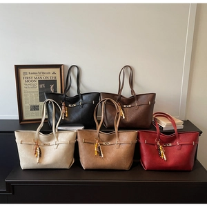 Detailed display of five large tote bags in various colors with bead charms and buckles