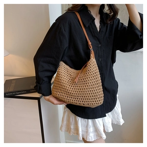 Detailed view of handmade crochet hollow mesh shoulder bag in a natural brown color
