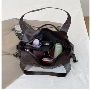 Large vintage brown faux leather tote bag showing spacious multi-compartment interior storage