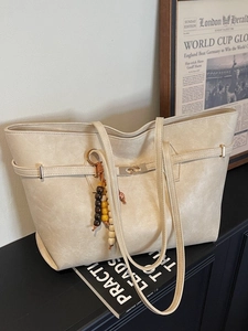 Elegant beige oversized tote bag with silver buckle and beaded charm for daily commute