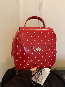 Fashionable red polka dot backpack with silver clasp and chain straps for women