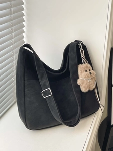 Minimalist black large capacity hobo shoulder bag with a cute plush puppy pendant