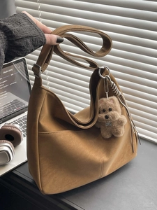 Minimalist large brown hobo shoulder bag with a cute plush dog pendant accessory