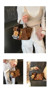 Close-up of a brown tote bag featuring a gold buckle and a cute teddy bear charm