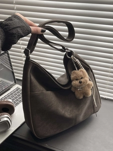 Minimalist large brown shoulder bag with vintage texture and cute plush puppy keychain