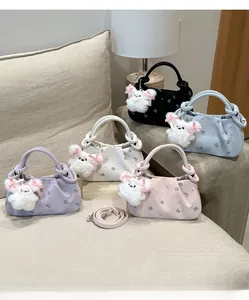 Detail of five mini dumpling bags in floral prints with cute plush bunny charms