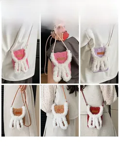 Detail view of handmade plush rabbit ear crossbody bags in four vibrant colors