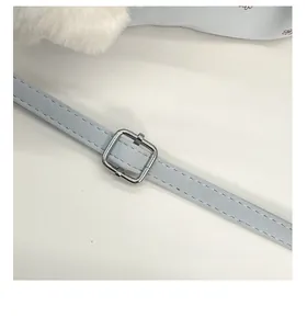 Detail of adjustable blue faux leather strap with silver buckle on floral shoulder bag