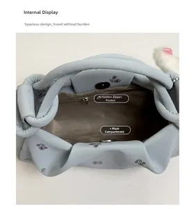 Internal view of floral print dumpling bag featuring magnetic closure and zip pocket