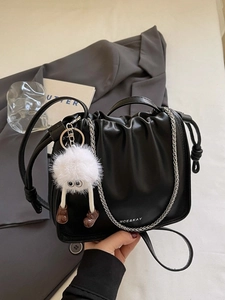 Chic black pleated cloud bucket bag with silver chain and white fluffy doll pendant